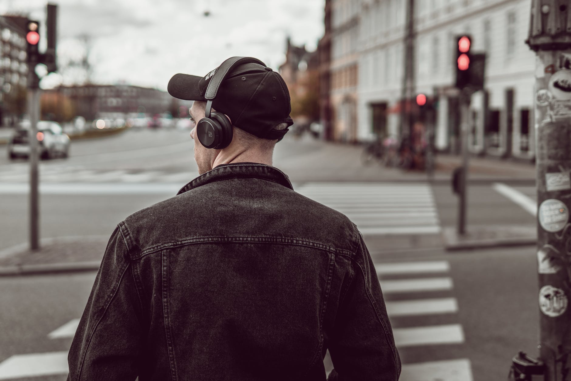 man listening to music on city street