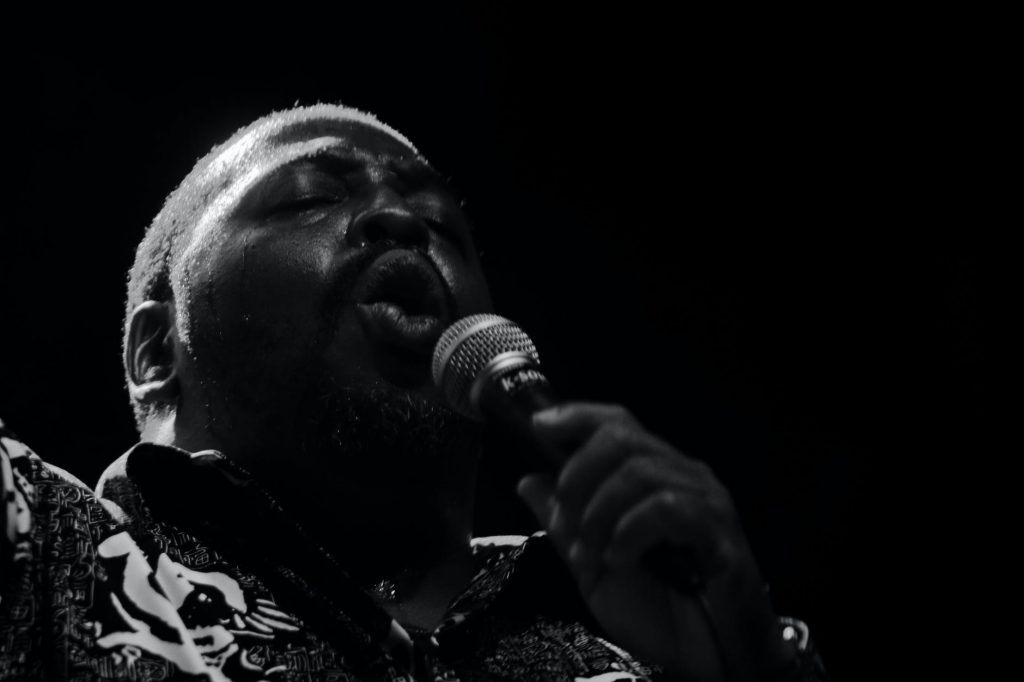 monochrome photo of man singing