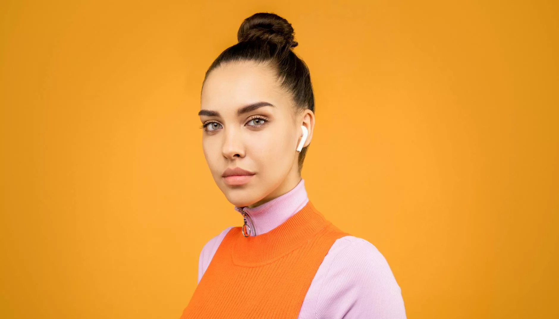 portrait photo of woman wearing pink turtleneck