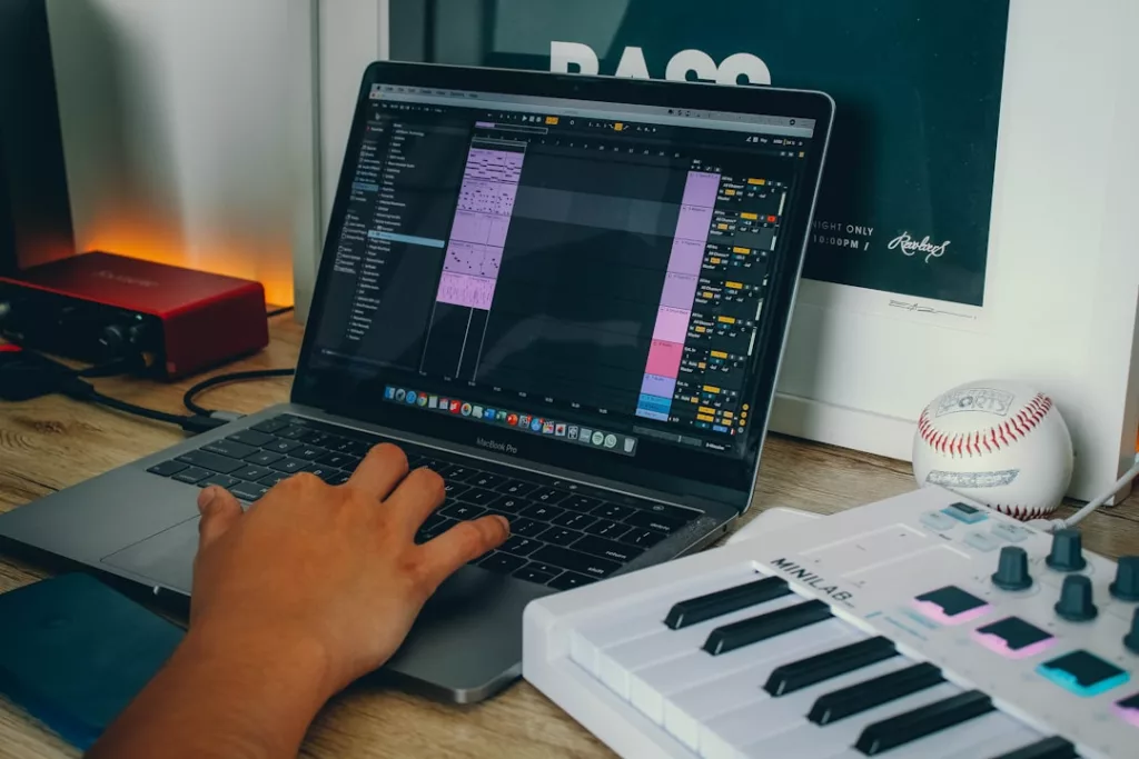 How to build artist website for music - a person using a laptop computer on a desk