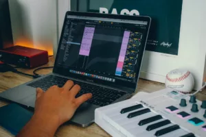 How to build artist website for music - a person using a laptop computer on a desk