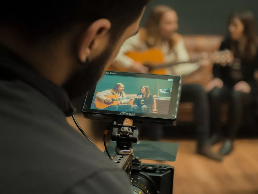 Music video promotion budget tips - a man holding a camera