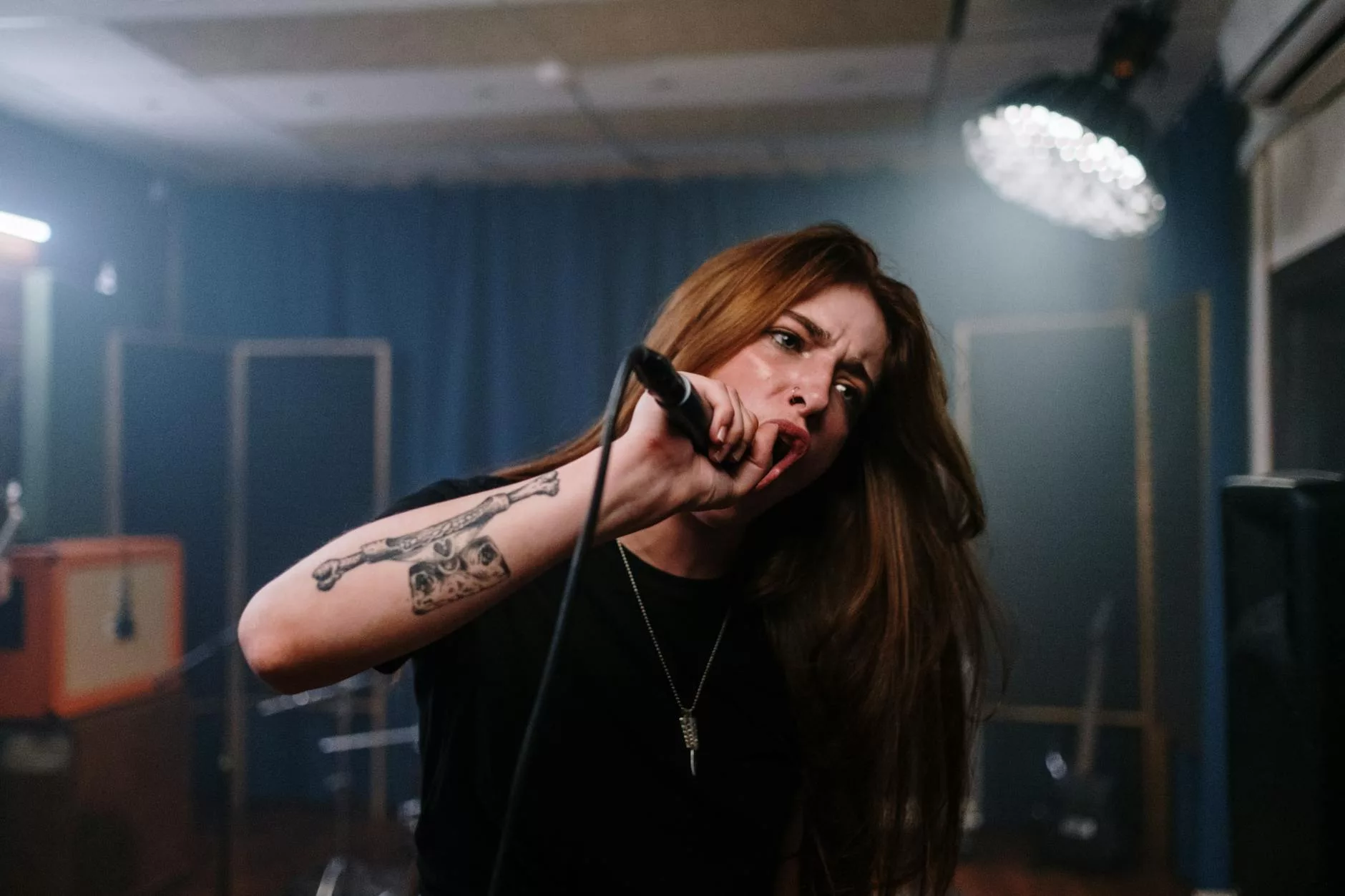 a tattooed woman singing