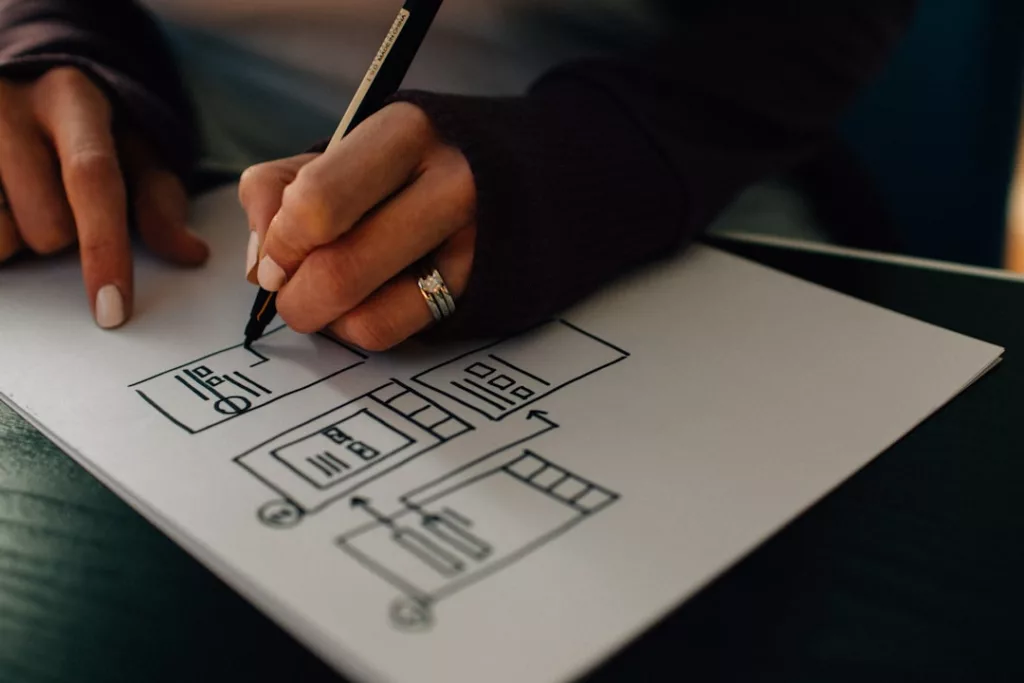 How to build artist website for music - person writing on white paper