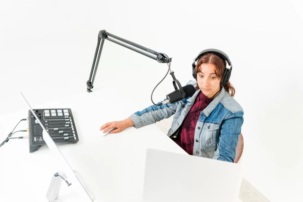 How to get radio airplay independently - a person wearing headphones and sitting at a desk with a computer