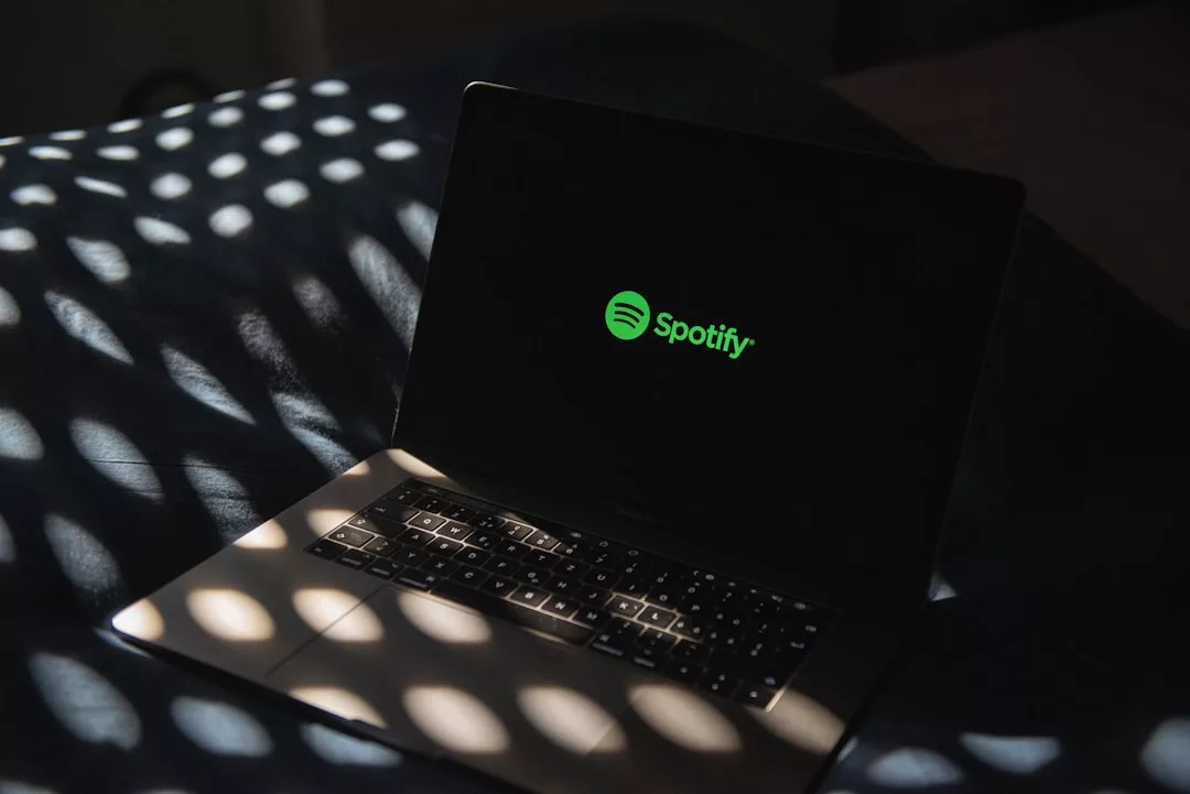 Spotify clips feature for artists - a laptop computer sitting on top of a bed