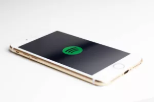 Spotify skip rate optimization - gold iPhone 7 displaying spotify logo