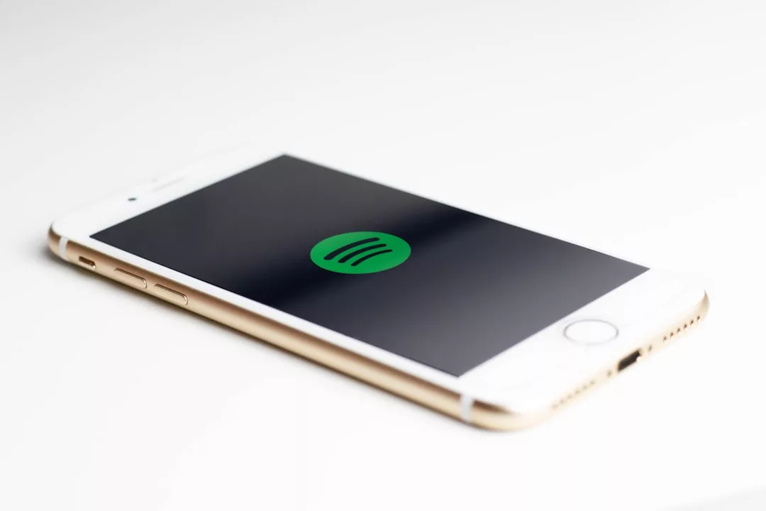 Spotify skip rate optimization - gold iPhone 7 displaying spotify logo